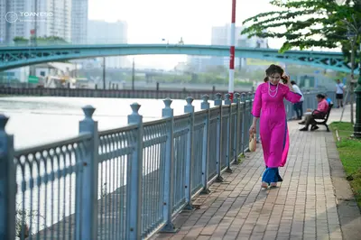 Dancesport competitor: Female dancer: long-sleeved, floor-length bright pink satin-like dress