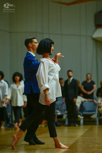 Dancesport competitor: Male dancer: blue patterned blazer and black trousers