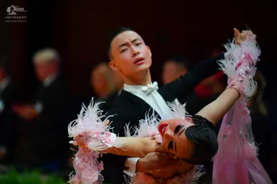 Dancesport competitor: Male dancer: black suit with a white shirt and white bow tie