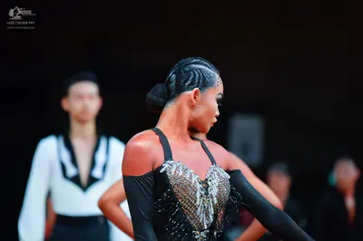 Dancesport competitor: Female dancer: black latin dance dress with silver sequin embellishments on the 