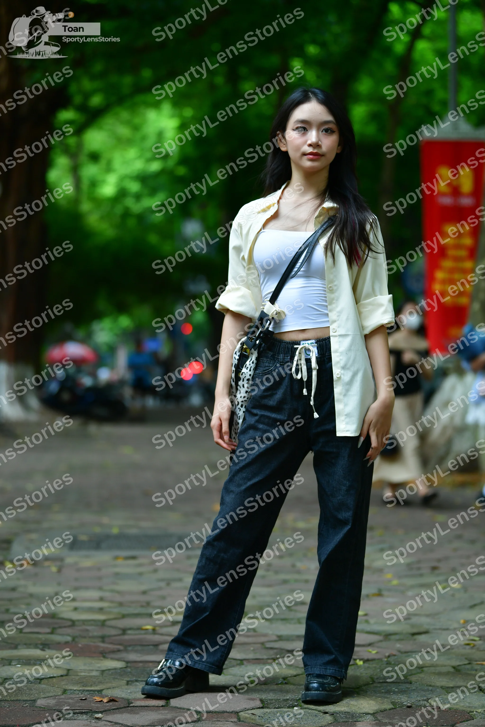 Dancesport competitor: Female dancer: white tank top, cream-colored unbuttoned long-sleeve shirt, and b