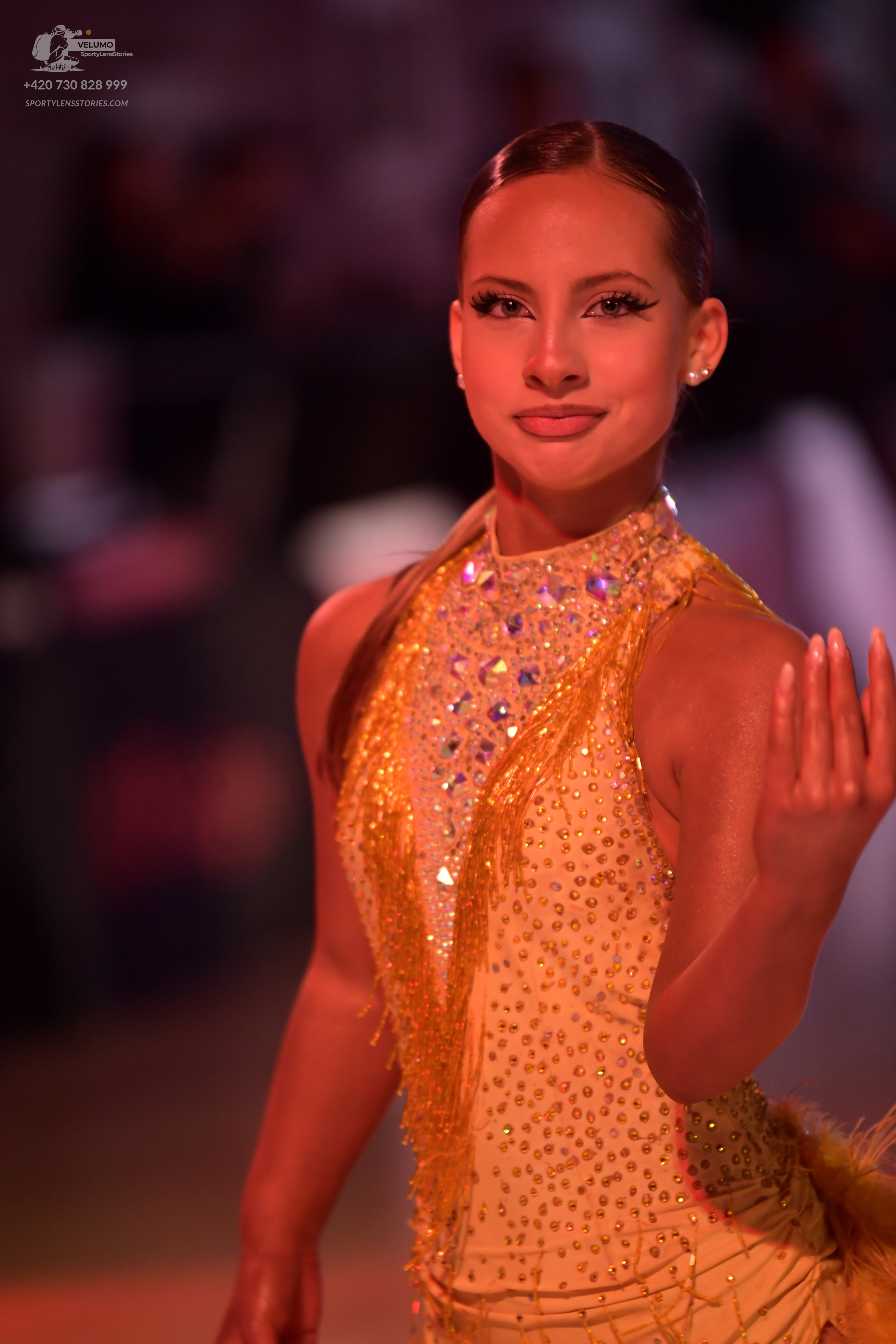Dancesport competitor: Female dancer: gold latin dress with rhinestones and fringe