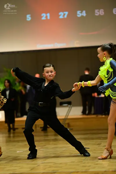 Dancesport competitor: Male dancer: black long-sleeved shirt and black trousers