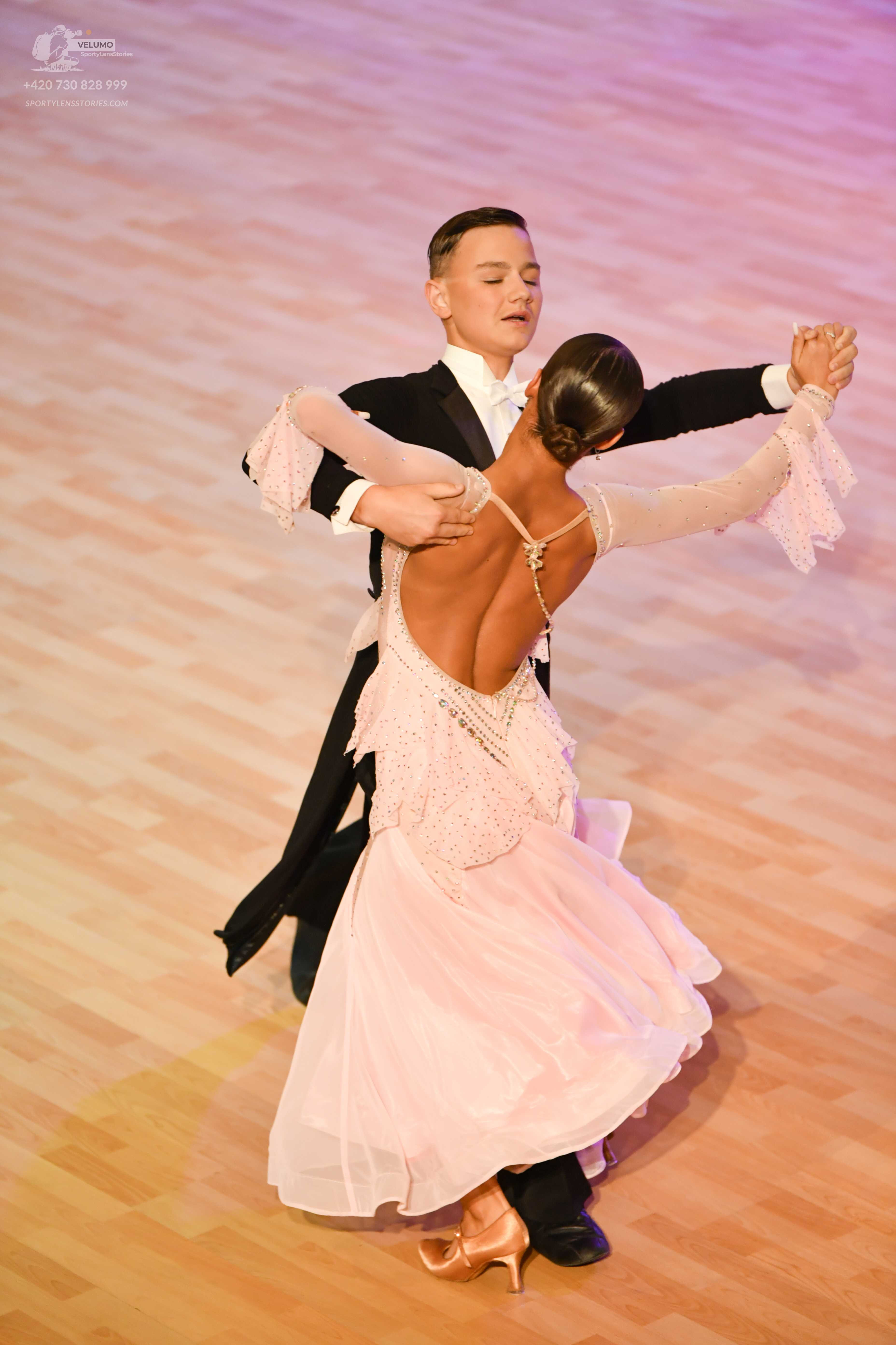 Dancesport competitor: Male:** Black tail suit with white sequin lapels and cuffs