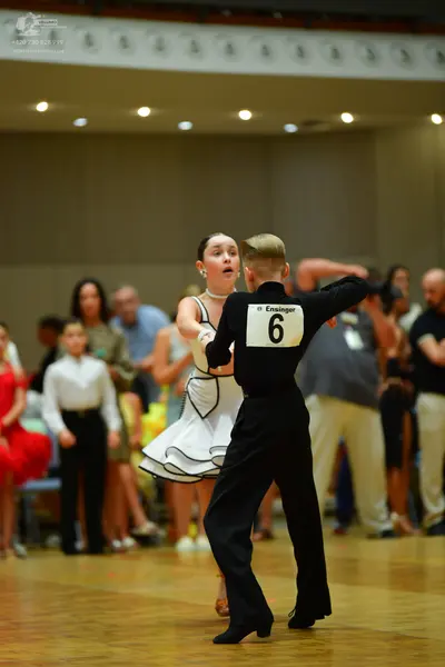 Dancesport competitor: Male dancer: black long-sleeved shirt and black trousers