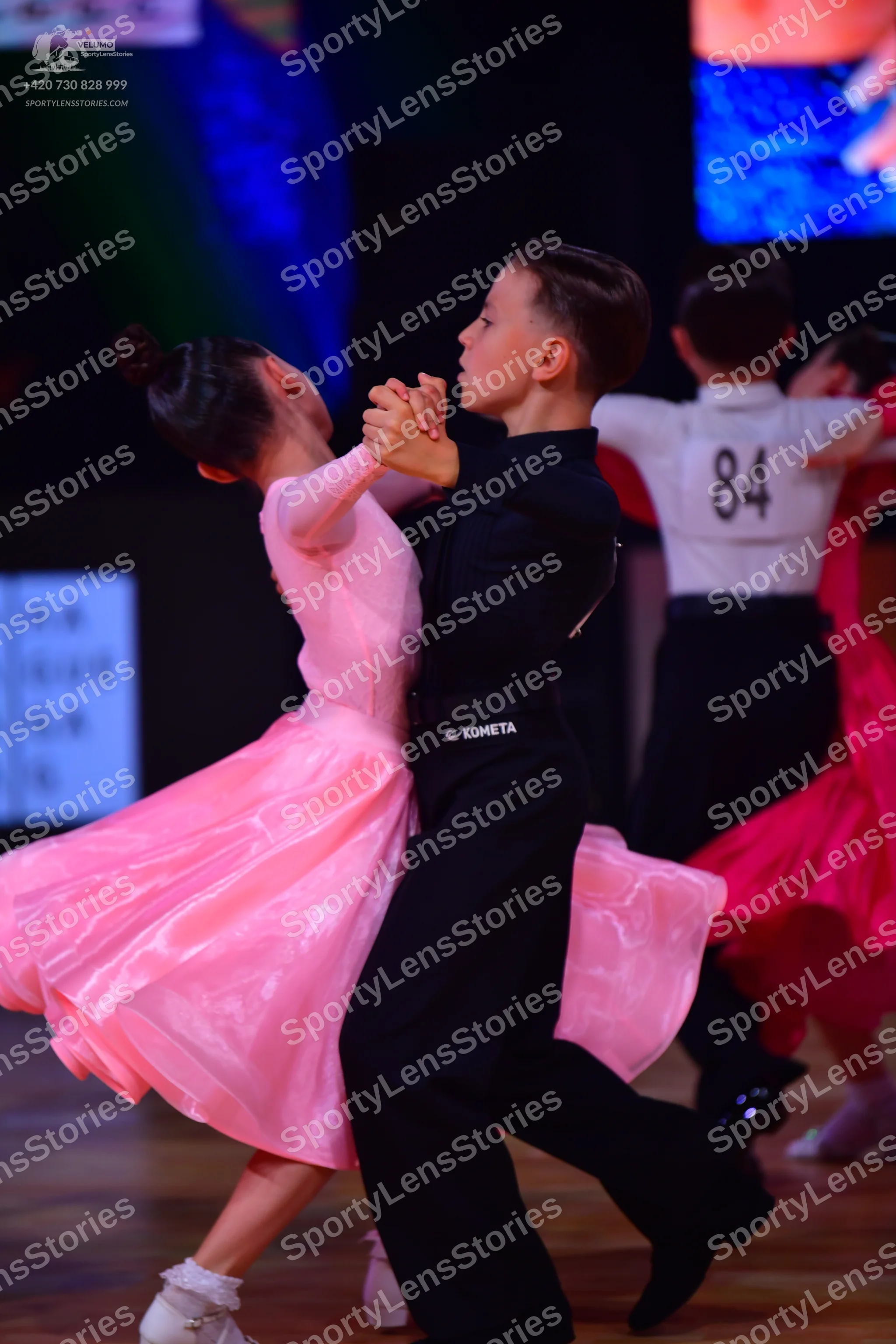 Dancesport competitor: Female dancer: pink satin ballroom dress with a full skirt