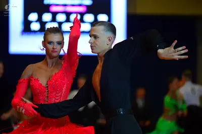 Dancesport competitor: Male dancer: black long-sleeved shirt and trousers