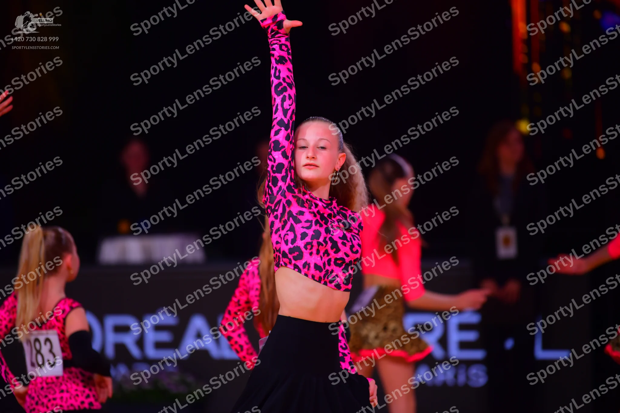 Dancesport competitor: Female dancer 1: pink and black leopard print Latin dress