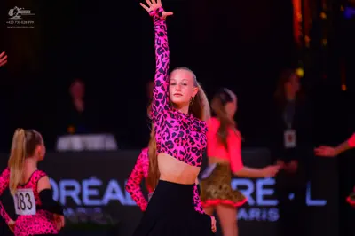Dancesport competitor: Female dancer 1: pink and black leopard print Latin dress