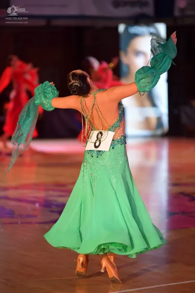 Dancesport competitor: Female dancer in foreground: mint green ballroom dress with a sequined and beade