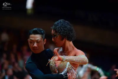 Dancesport competitor: Male dancer: black long-sleeved dance top