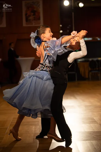 Dancesport competitor: Male dancer: black waistcoat, white long-sleeved shirt, and black trousers