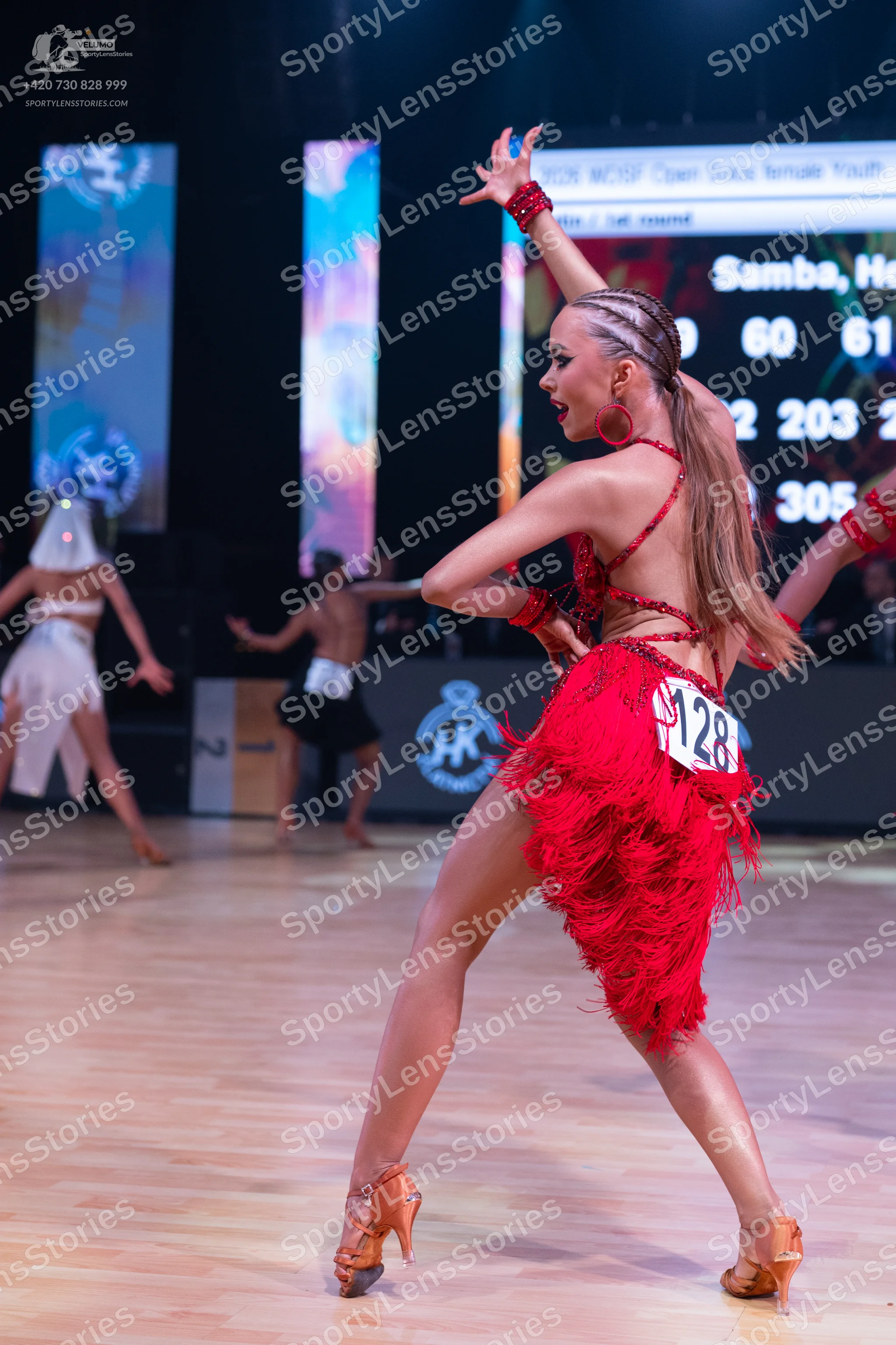 Dancesport competitor: Main female dancer: red latin dress with fringe and red accessories