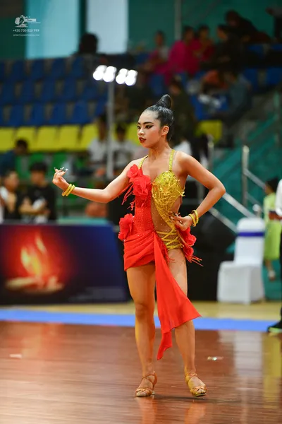 Dancesport competitor: ** Red Latin Dress
*   **Color:** Primarily bright red