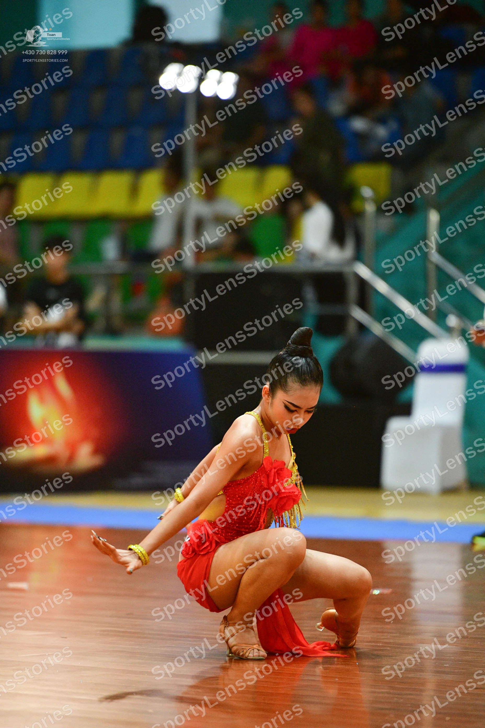 Dancesport competitor: ** Red Latin Dress
*   **Color:** Primarily red
*   **Fabric:** Appears to be a 
