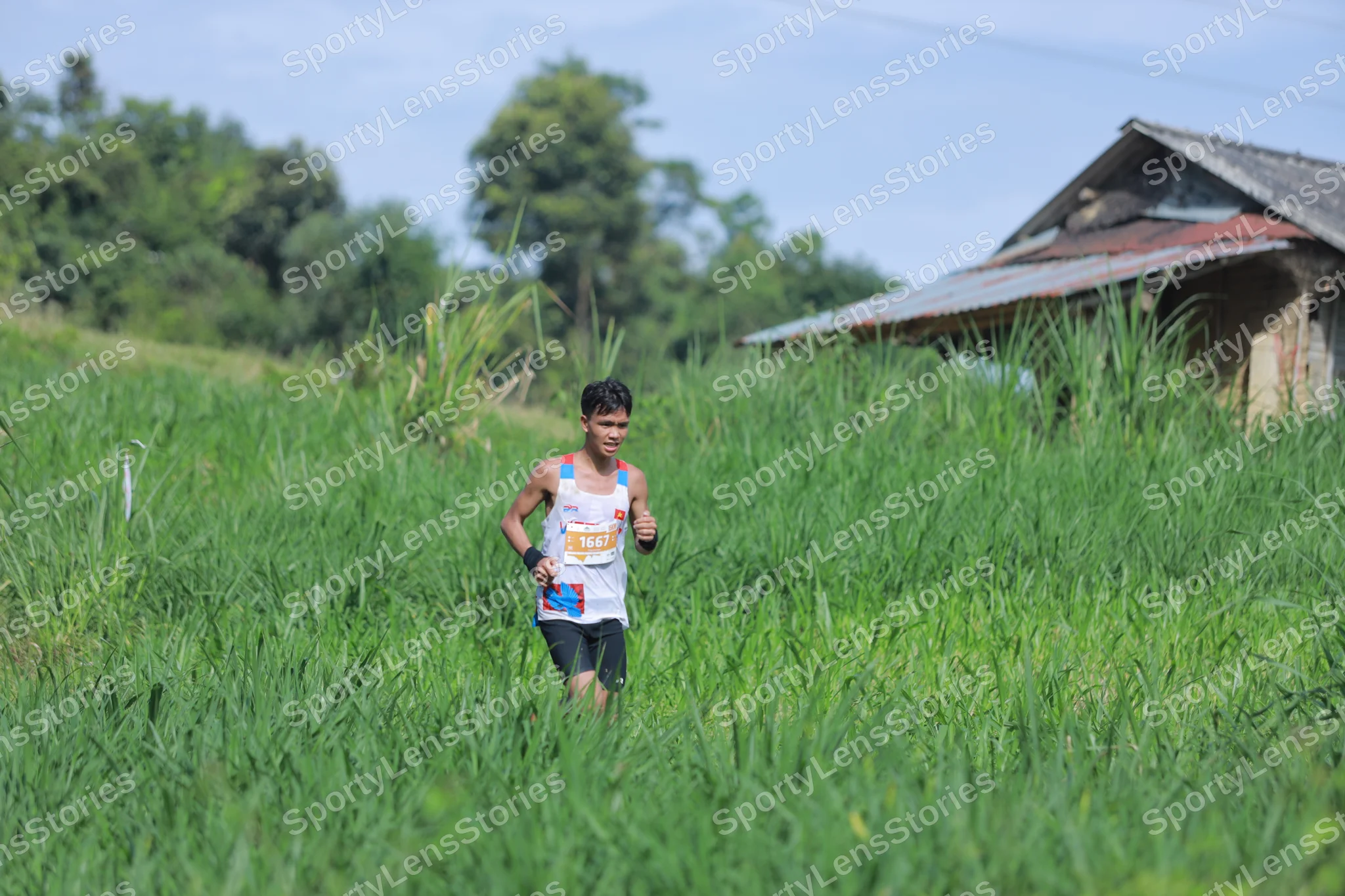 Marathon runner: Runner 1: white tank top with orange and blue details, black shorts, black wrist
