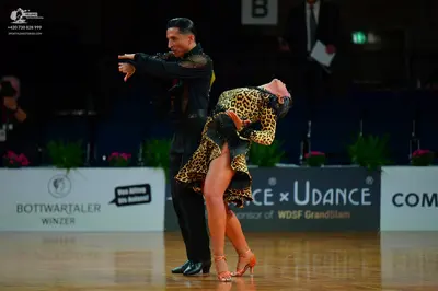 Dancesport competitor: Male dancer: black long-sleeved shirt with sequin details on shoulders and black
