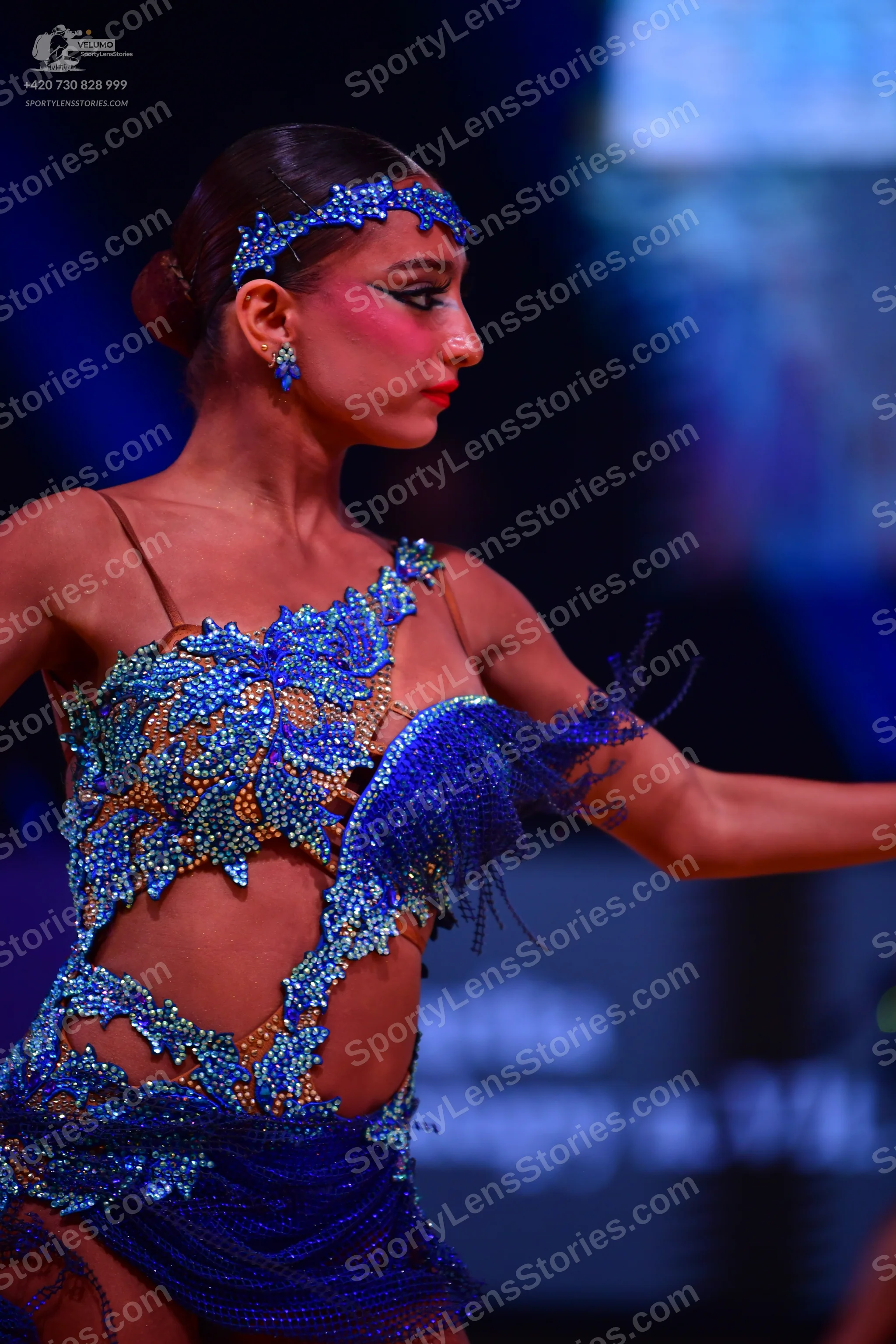 Dancesport competitor: Female dancer: blue latin dress with sequins, cut-outs, and fringe