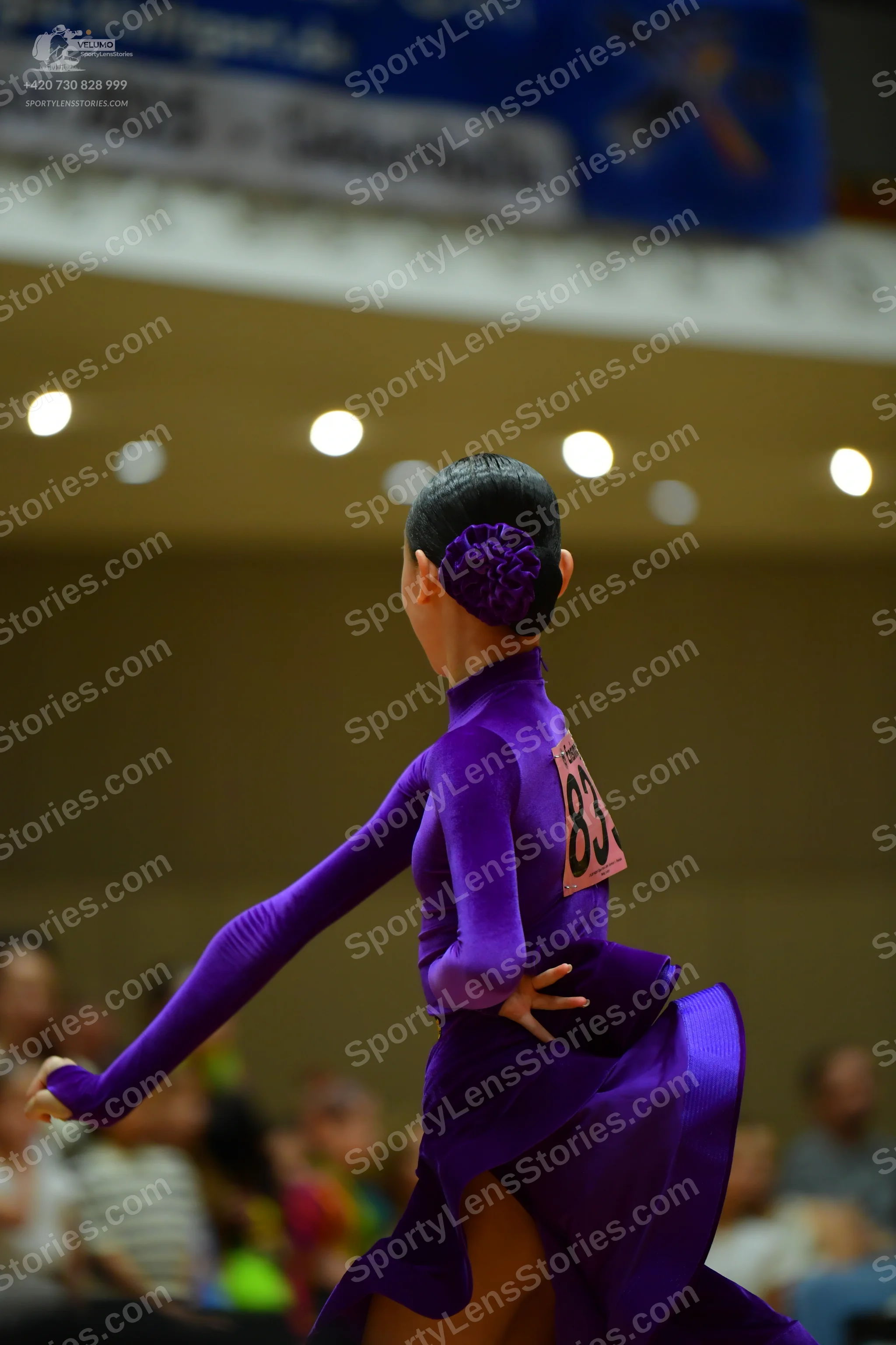 Dancesport competitor #83: Female dancer: purple long-sleeved latin dress with a high neck and flowing skir