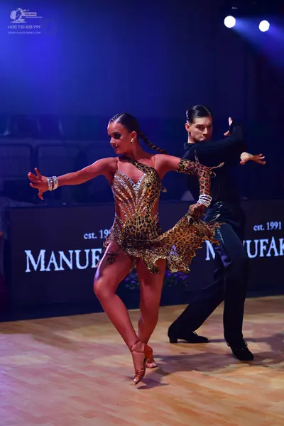 Dancesport competitor: Female dancer: leopard print latin dress with heavy sequin and crystal embellish