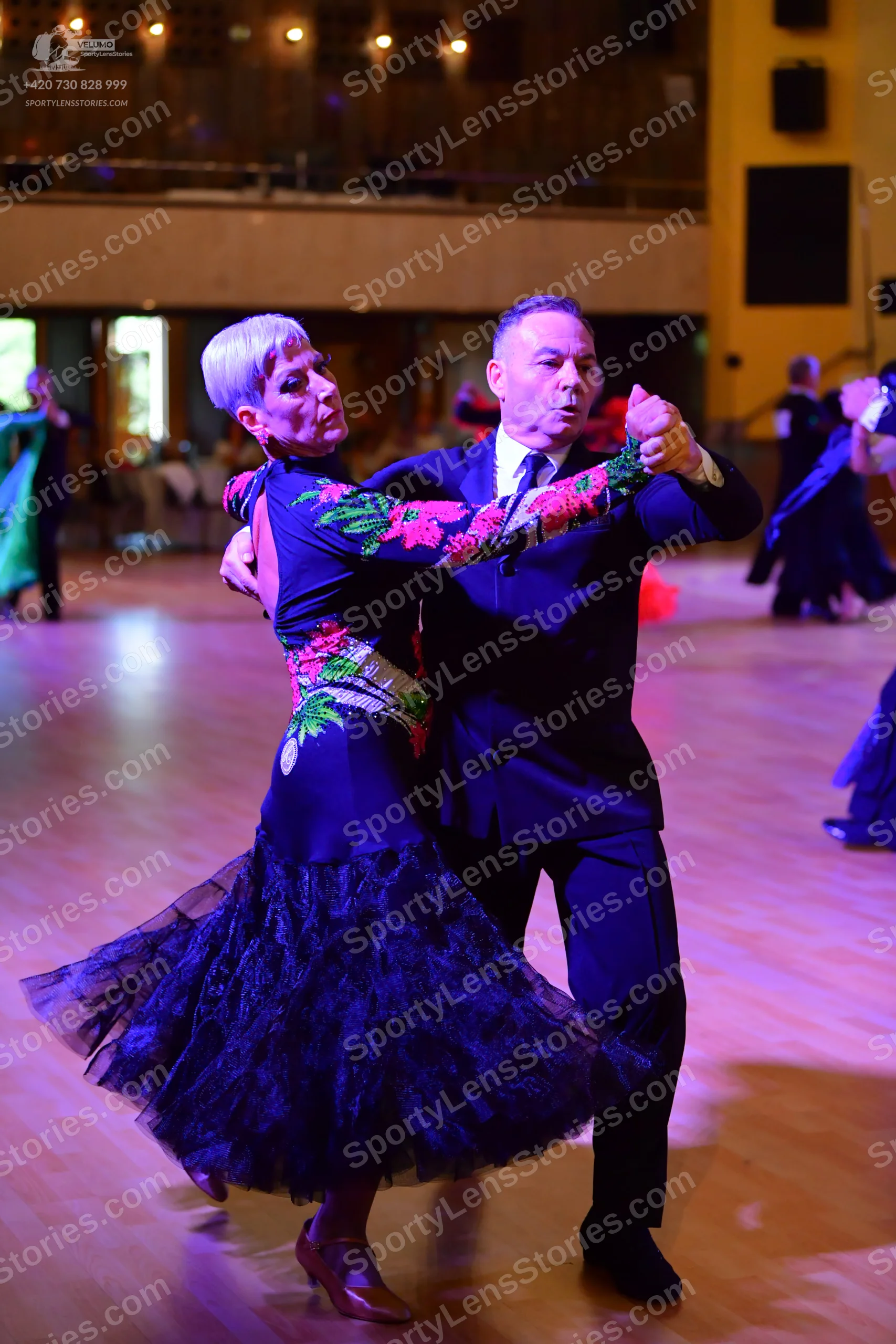 Dancesport competitor: Male:** Black tail suit with shimmering, dark grey/black sequin lapels