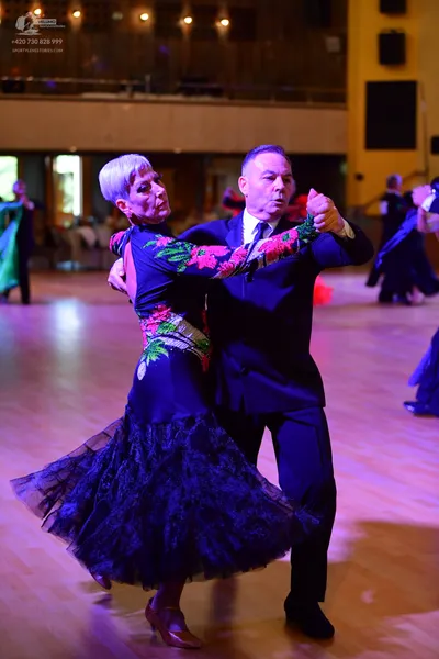 Dancesport competitor: Male:** Black tail suit with shimmering, dark grey/black sequin lapels