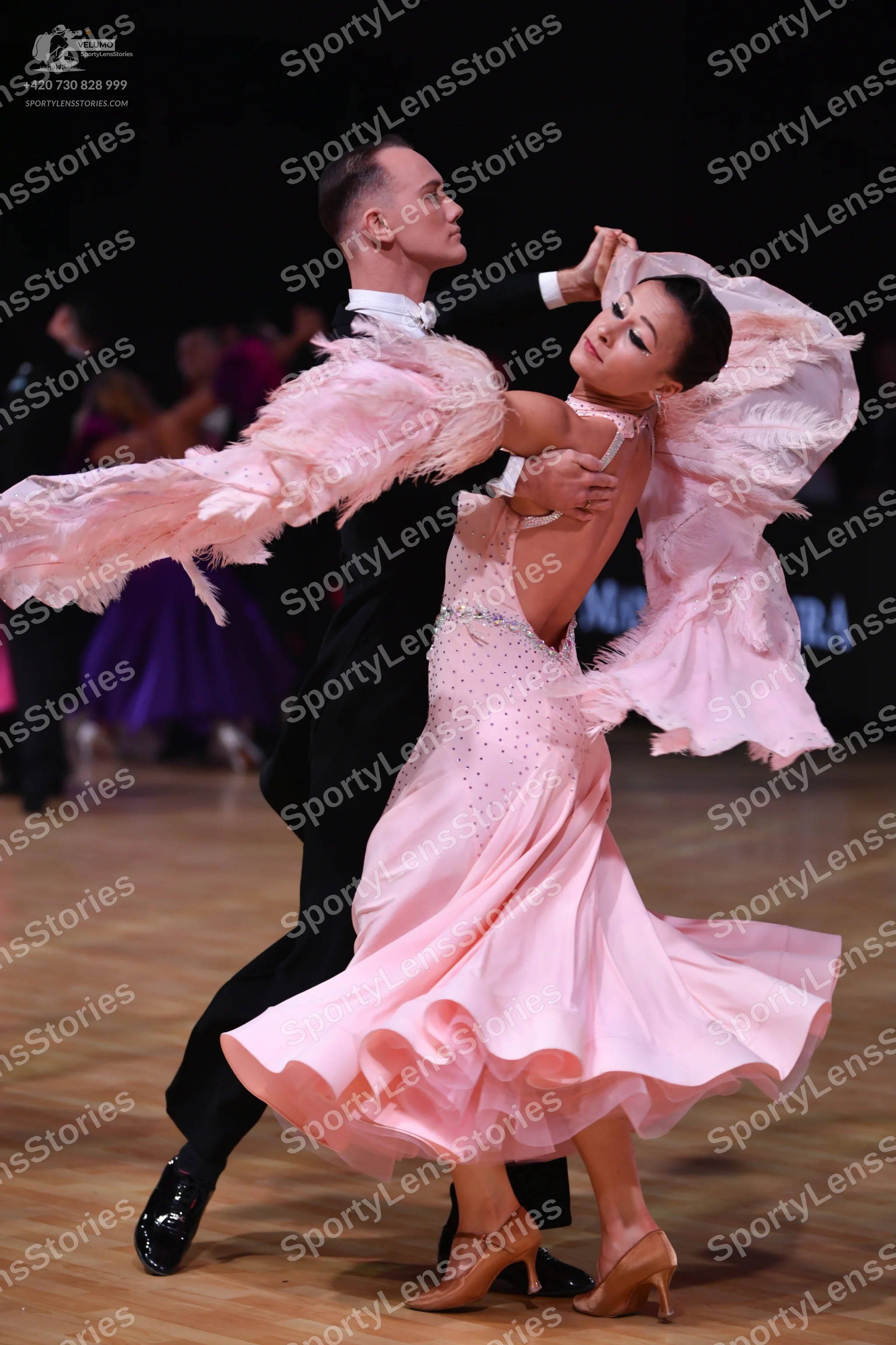 Dancesport competitor: Male dancer: black suit with a white shirt collar and black patent leather shoes