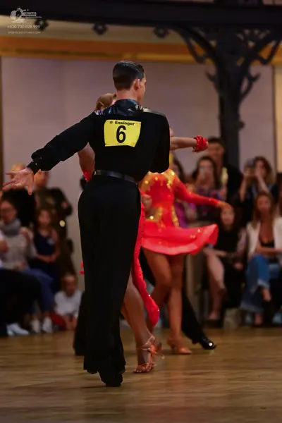 Dancesport competitor: Male dancer: black long-sleeved shirt and black trousers