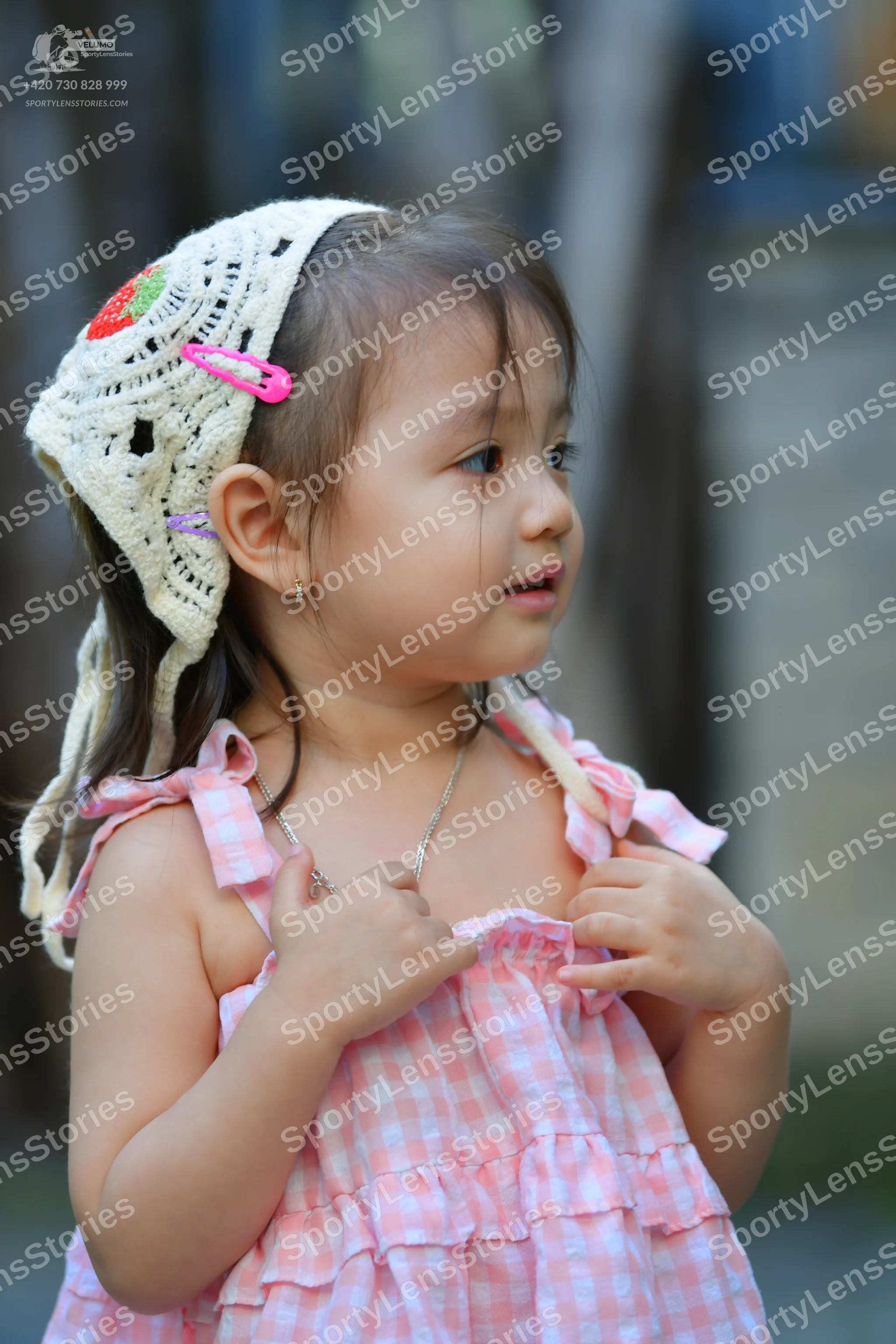 Dancesport competitor: Female dancer: pink and white gingham sleeveless dress with ruffled layers and s