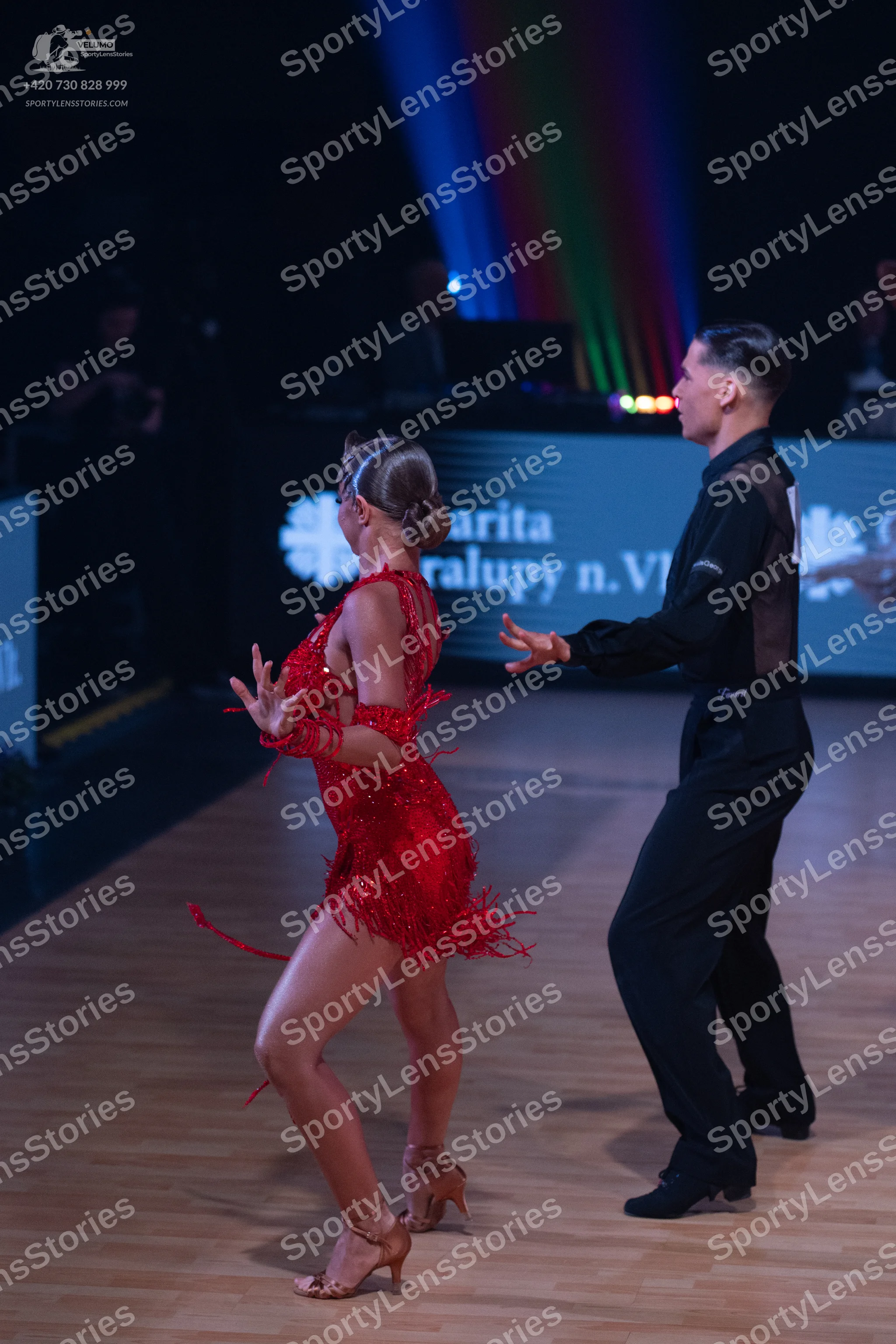 Dancesport competitor: Female dancer: red sequined Latin dress with fringe