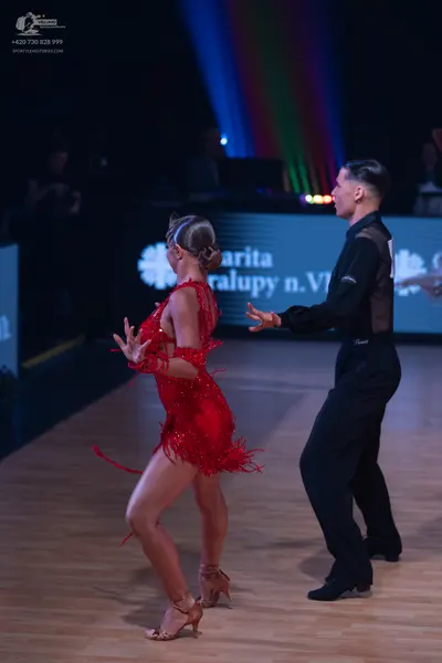 Dancesport competitor: Female dancer: red sequined Latin dress with fringe