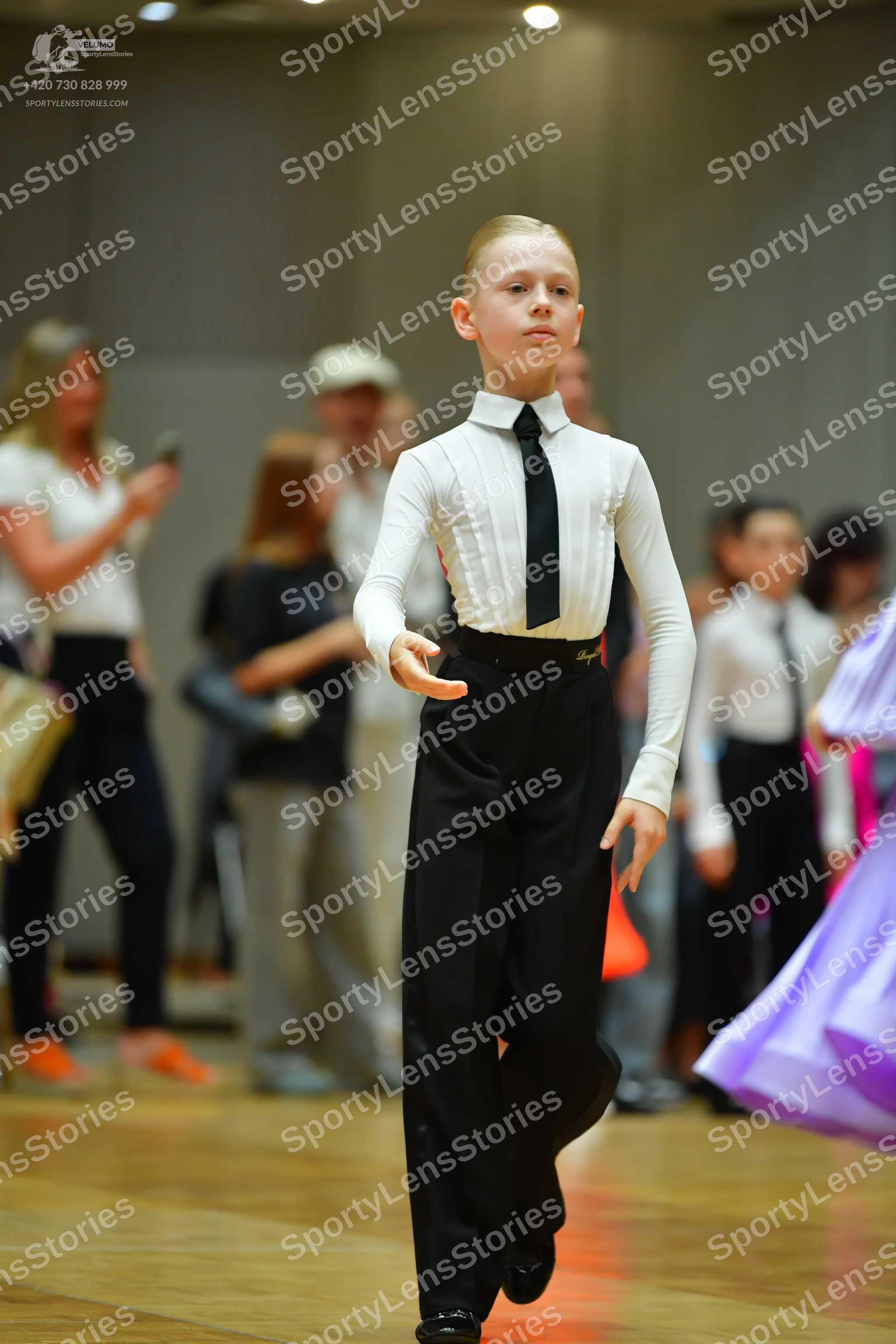 Dancesport competitor: Main male dancer: white long-sleeved shirt, black necktie, and black trousers