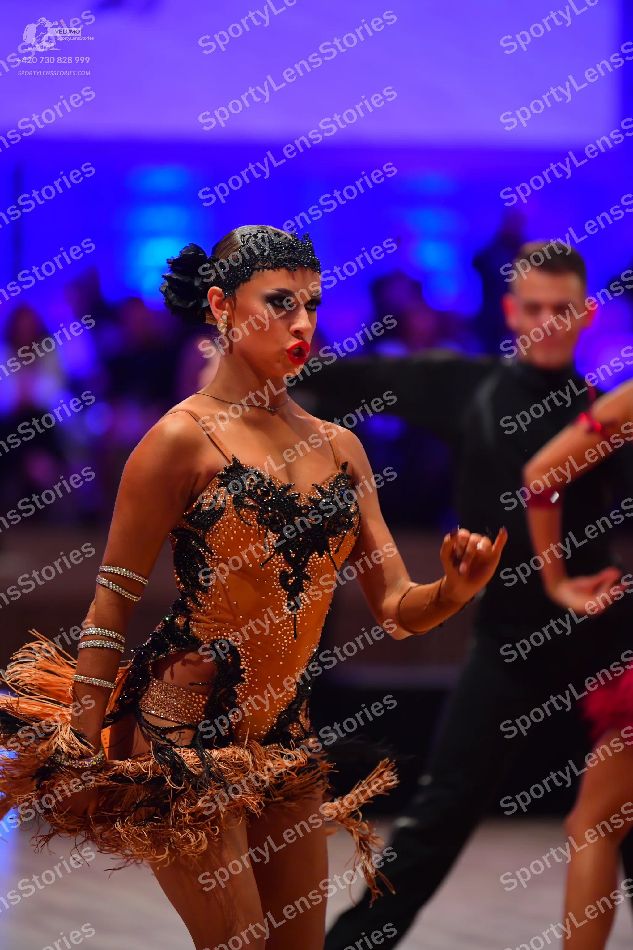 Dancesport competitor: Female dancer: tan/nude Latin dance dress with black sequin and lace embroidery