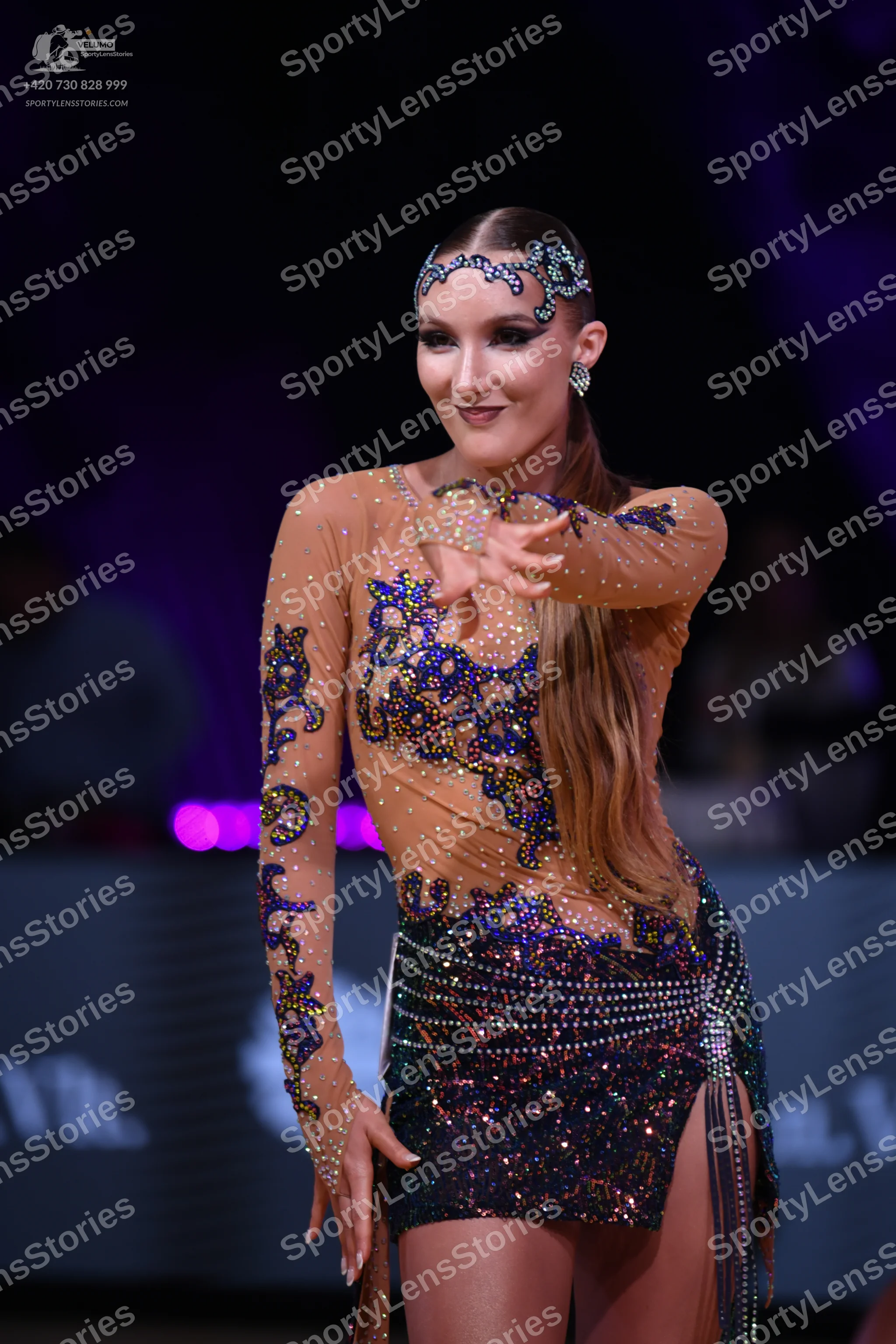 Dancesport competitor: Female dancer: Latin dance dress featuring a nude-colored mesh bodice and long s