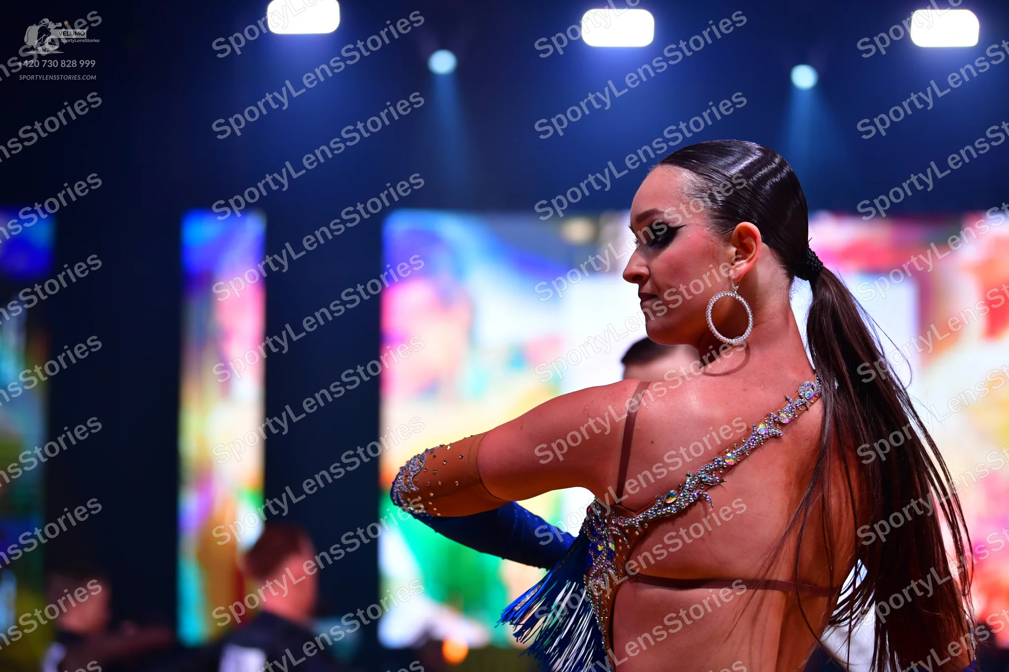 Dancesport competitor: Female dancer: Latin dance costume with blue and silver/gold sequin and crystal