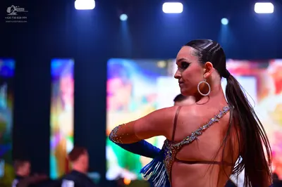 Dancesport competitor: Female dancer: Latin dance costume with blue and silver/gold sequin and crystal 
