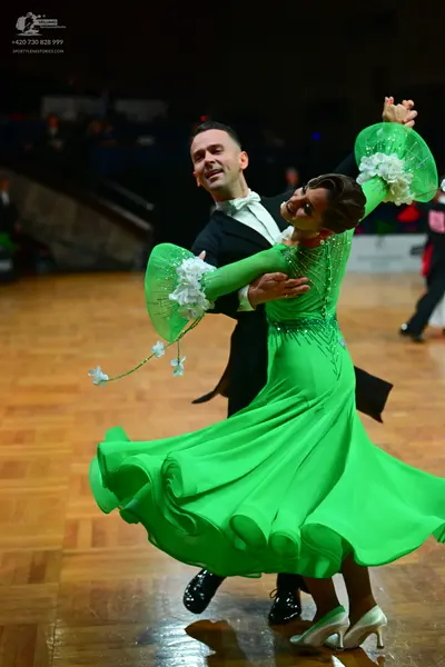 Dancesport competitor: Male dancer: black ballroom suit with a white shirt and white bowtie