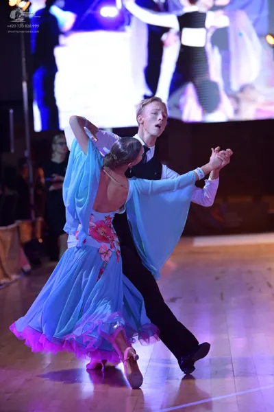 Dancesport competitor: Female dancer: light blue ballgown with a white bodice featuring pink floral pat