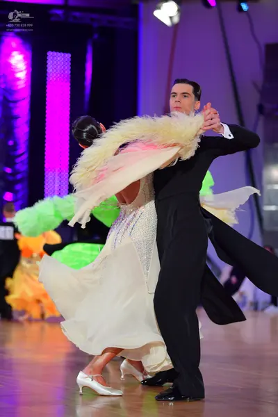 Dancesport competitor: Male dancer: black ballroom suit and black shoes