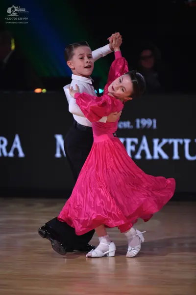 Dancesport competitor: Male dancer: white long-sleeved shirt and black trousers