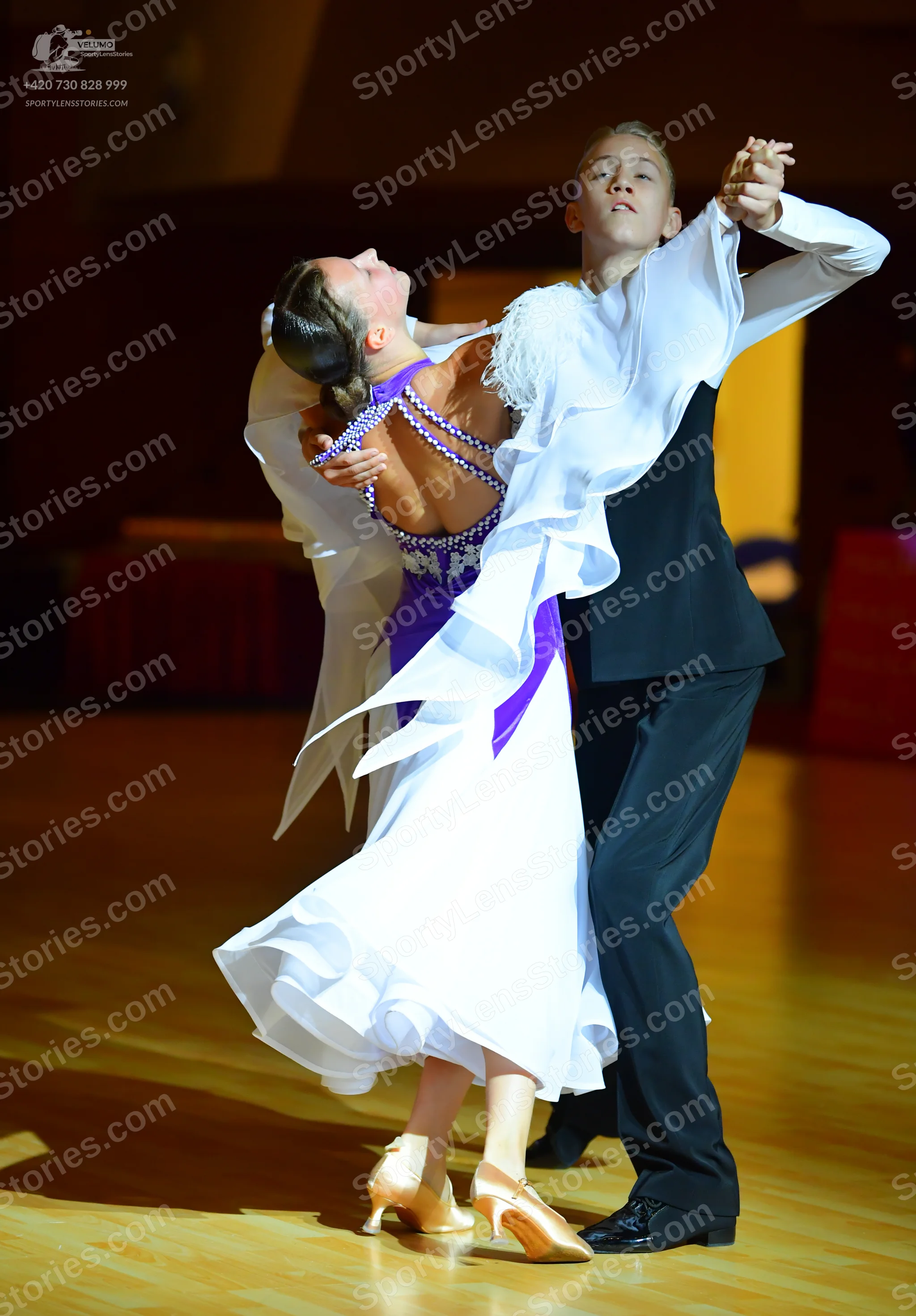 Dancesport competitor: Male dancer: black waistcoat and trousers with a white long-sleeved shirt featur