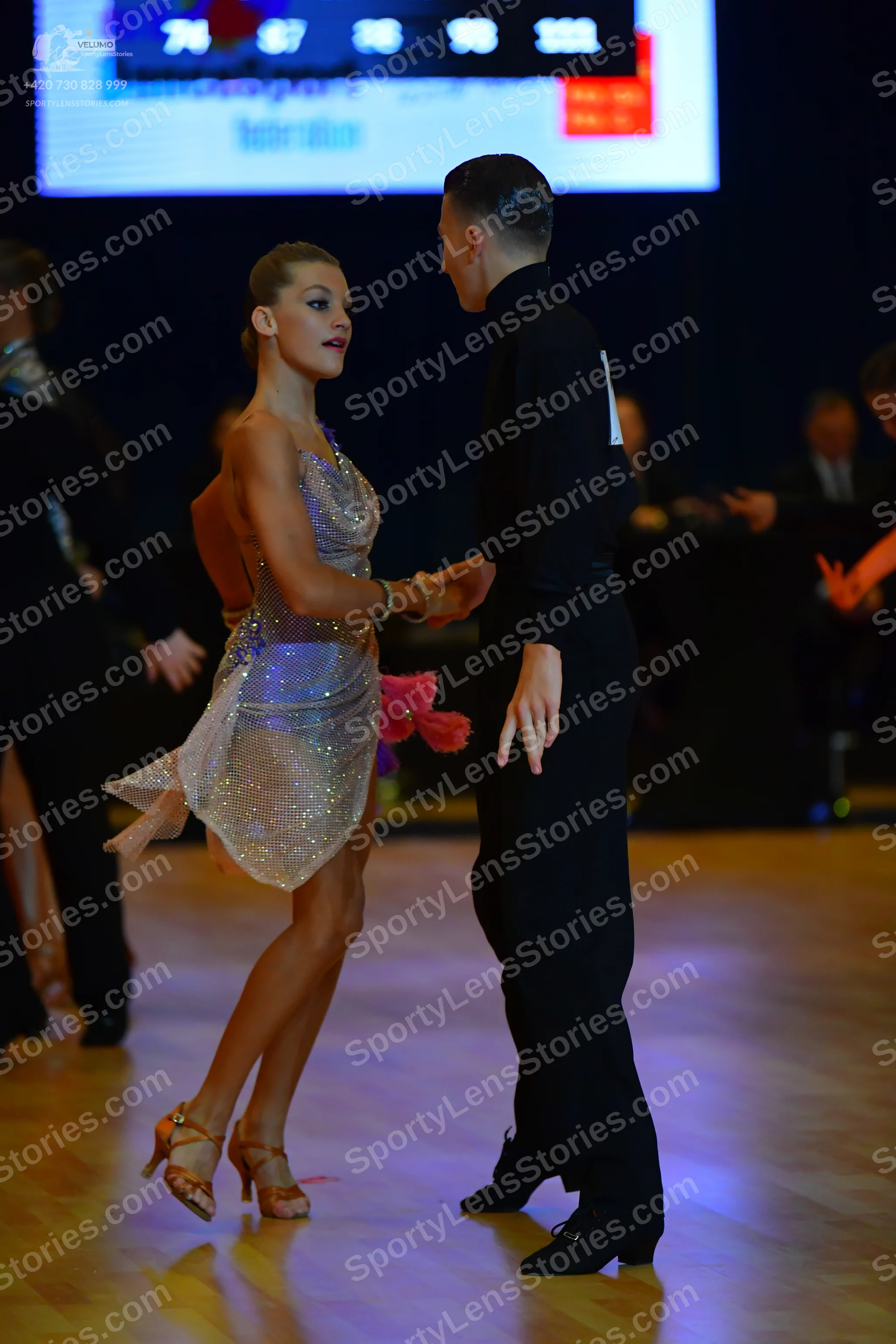Dancesport competitor: Female dancer: silver sequined Latin dress with thin straps