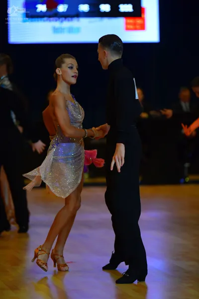 Dancesport competitor: Female dancer: silver sequined Latin dress with thin straps