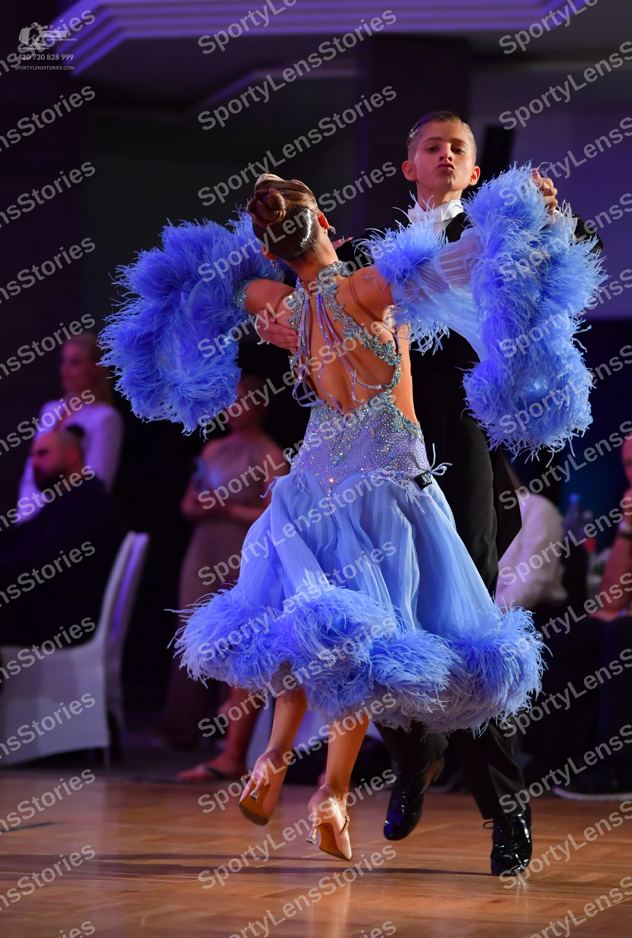 Dancesport competitor: Female dancer: light blue dance dress with a sequined bodice and voluminous ligh