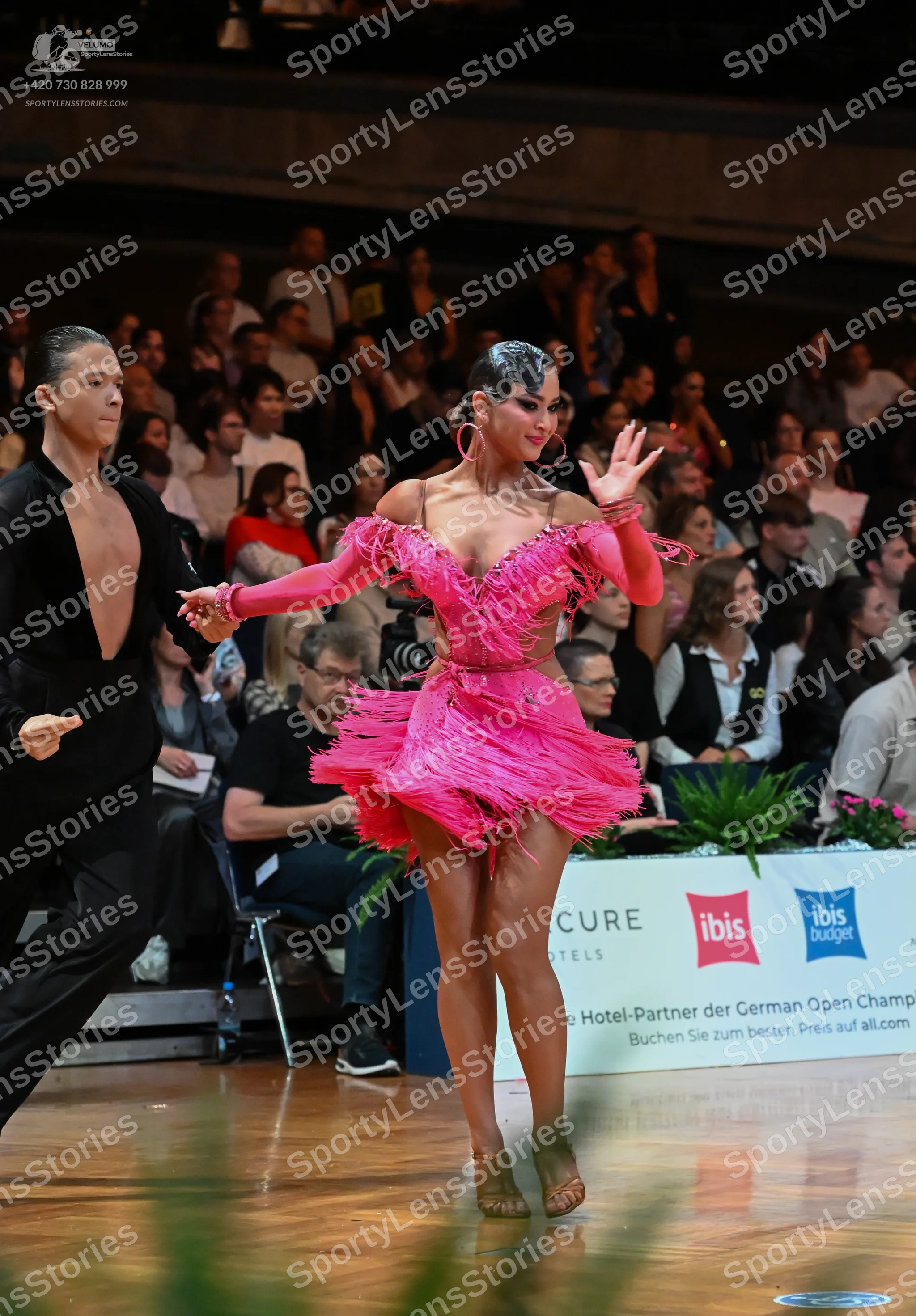 Dancesport competitor: Male dancer: black long-sleeved Latin dance shirt with an open chest and black t
