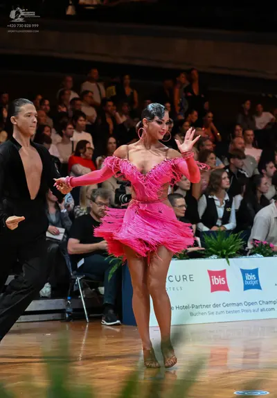 Dancesport competitor: Male dancer: black long-sleeved Latin dance shirt with an open chest and black t