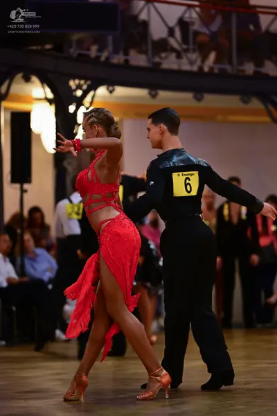 Dancesport competitor: Female dancer: red latin dress with cutouts