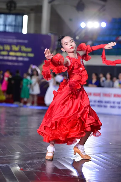 Dancesport competitor: ** Female - Red Latin Dress
*   **Color:** Primarily vibrant red