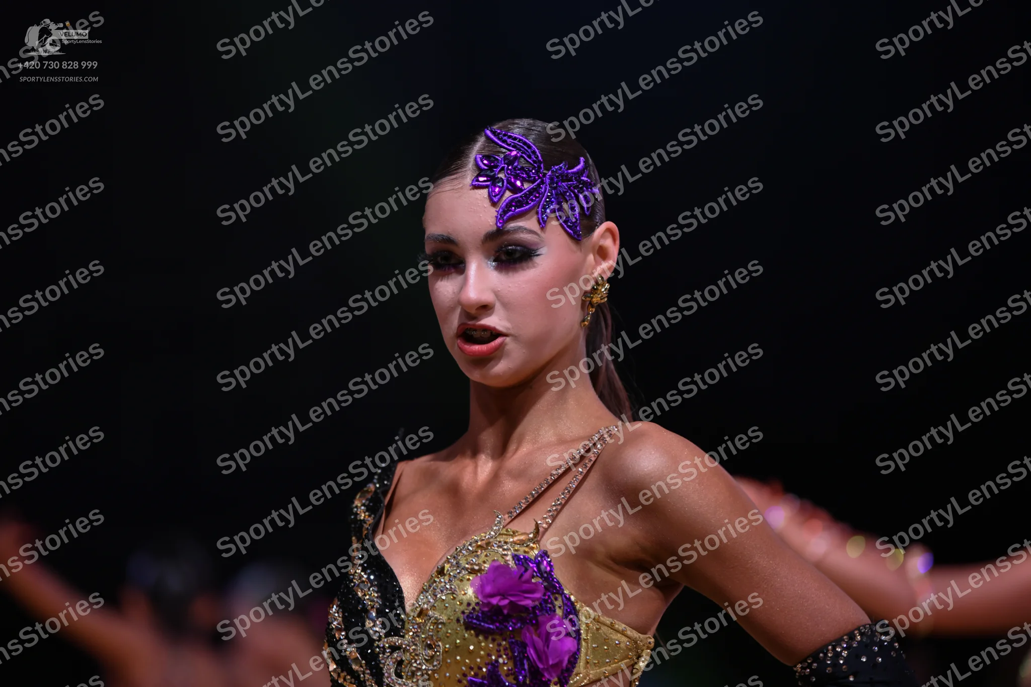Dancesport competitor: Female dancer: gold/champagne Latin dance top with sequins and embellishments, f
