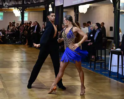 Dancesport competitor: Male dancer: black Latin dance top and trousers